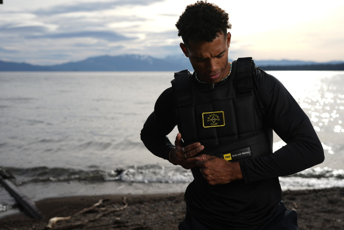 man putting on weight vest before walk