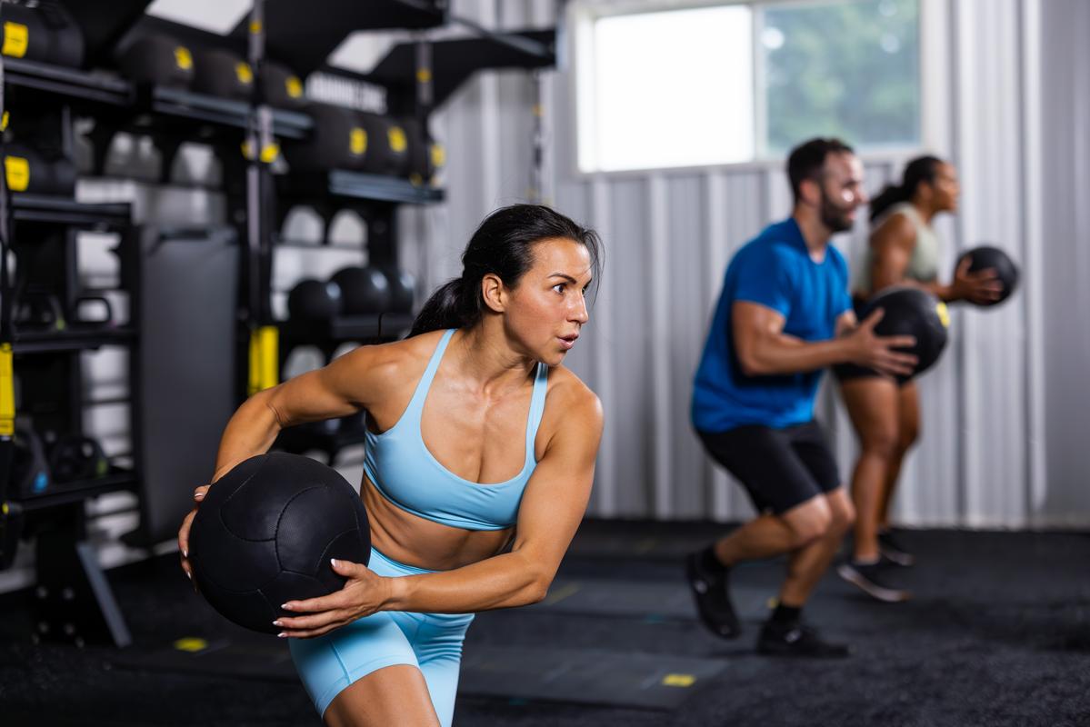 trx trainer doing medicine balls